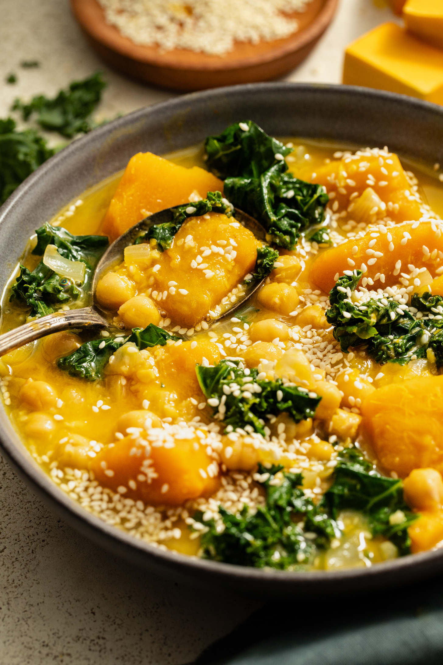 Spoon resting in a bowl of our 1-Pot Kabocha Chickpea Miso Soup