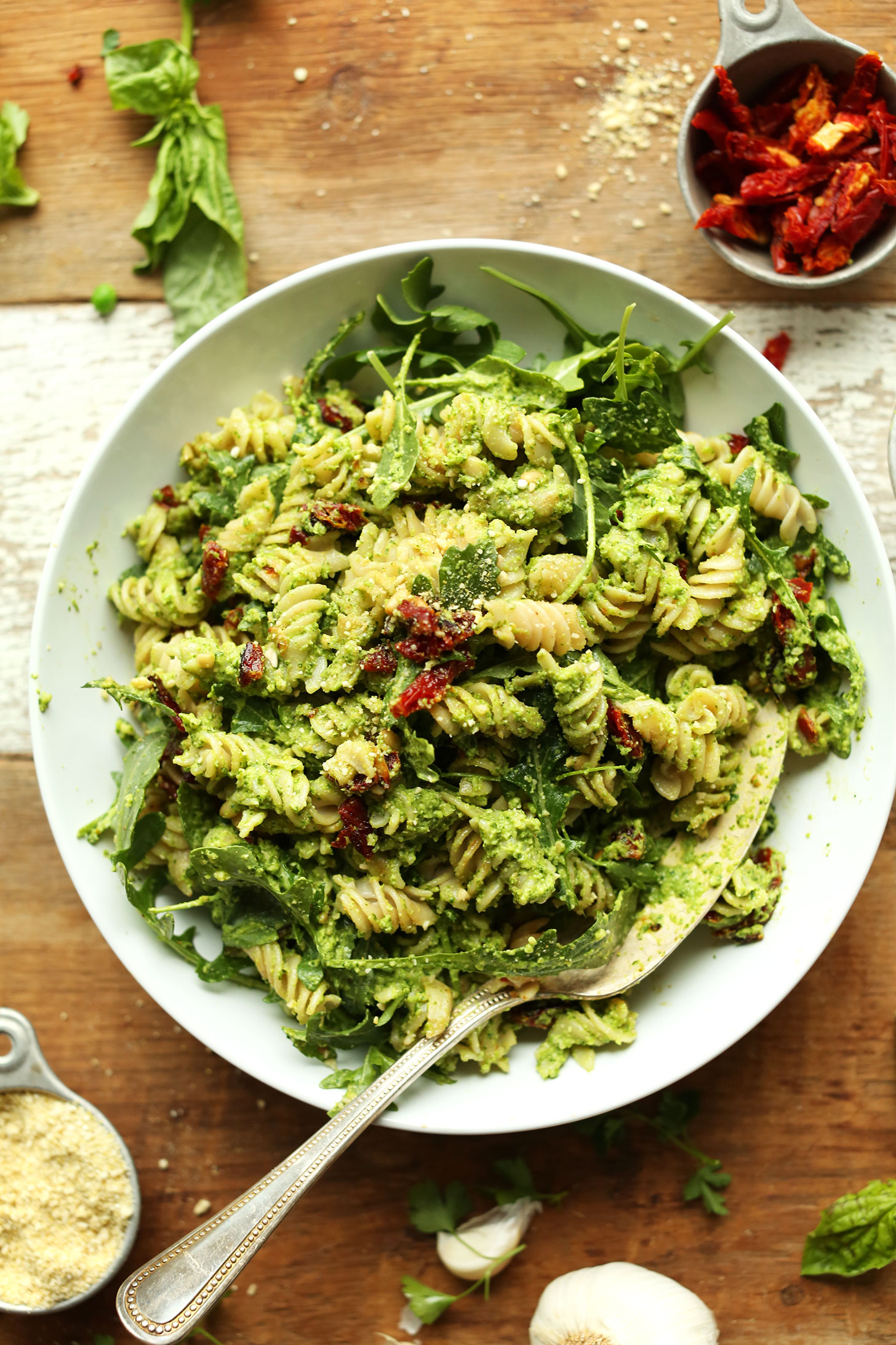 Big bowl filled with gluten-free vegan Pea Pesto Pasta with Sun-Dried Tomatoes and Arugula