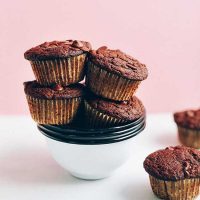 Stack of bowls piled high with Gluten-Free Chocolate Chocolate Chip Muffins