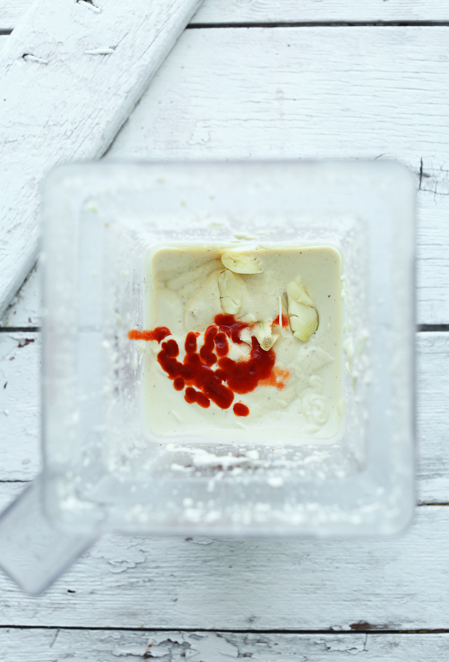 Blender with ingredients for making vegan Sriracha Aioli