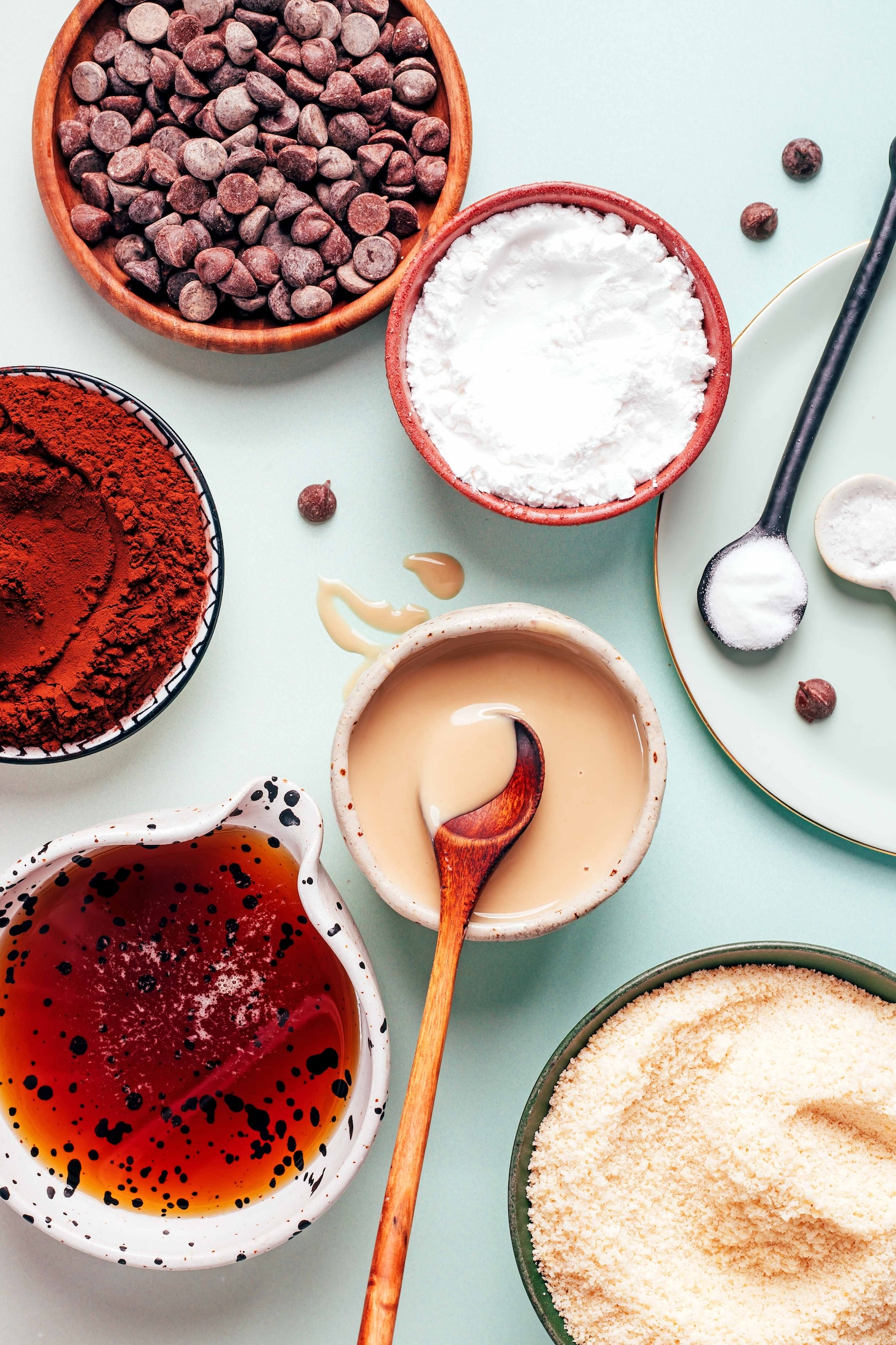 Chocolate chips, tapioca starch, baking soda, salt, almond flour, tahini, maple syrup, and cocoa powder