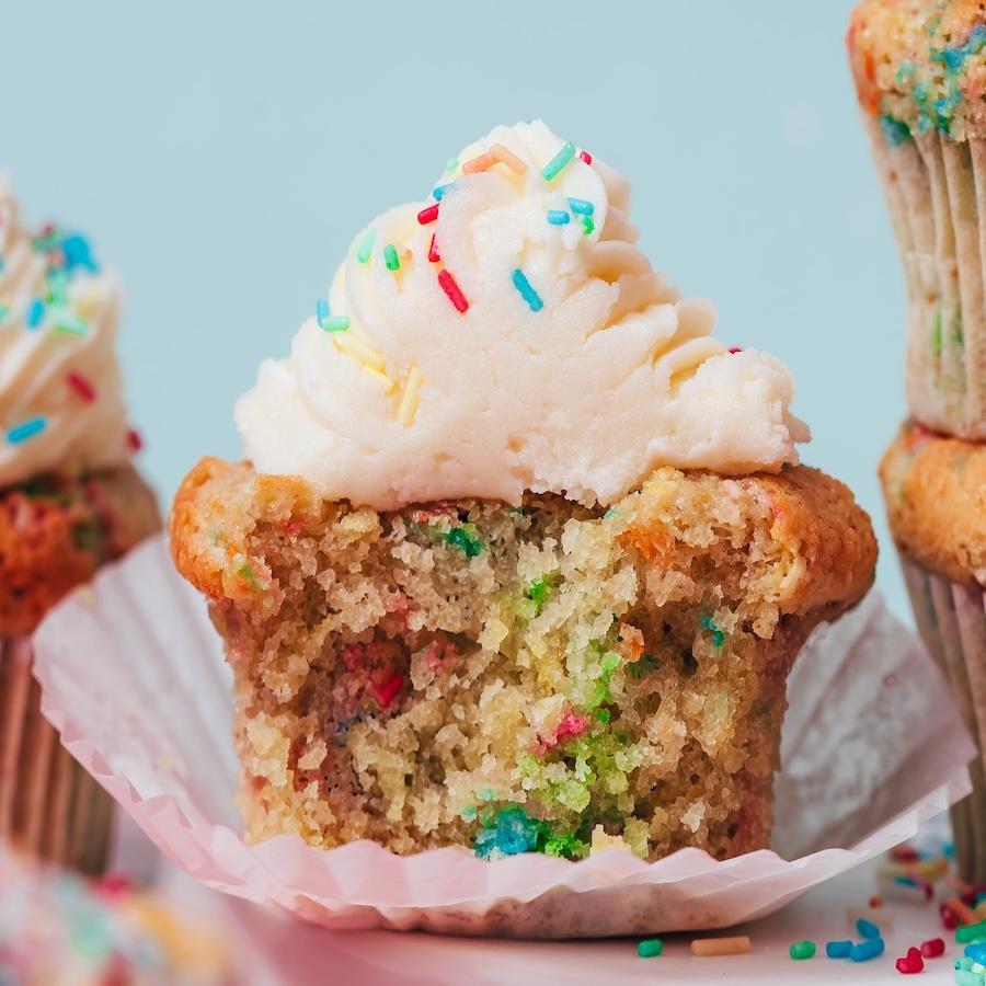 Close up photo showing the inside of a gluten-free funfetti cupcake