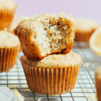Stack of vegan gluten-free lemon poppyseed muffins on a cooling rack