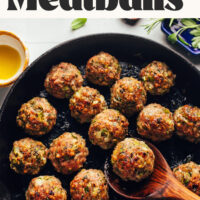 Cast iron skillet of meatballs with text above that says Thanksgiving Turkey Meatballs just 10 ingredients