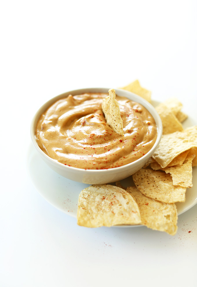 Big bowl of Vegan Queso with tortilla chips around it