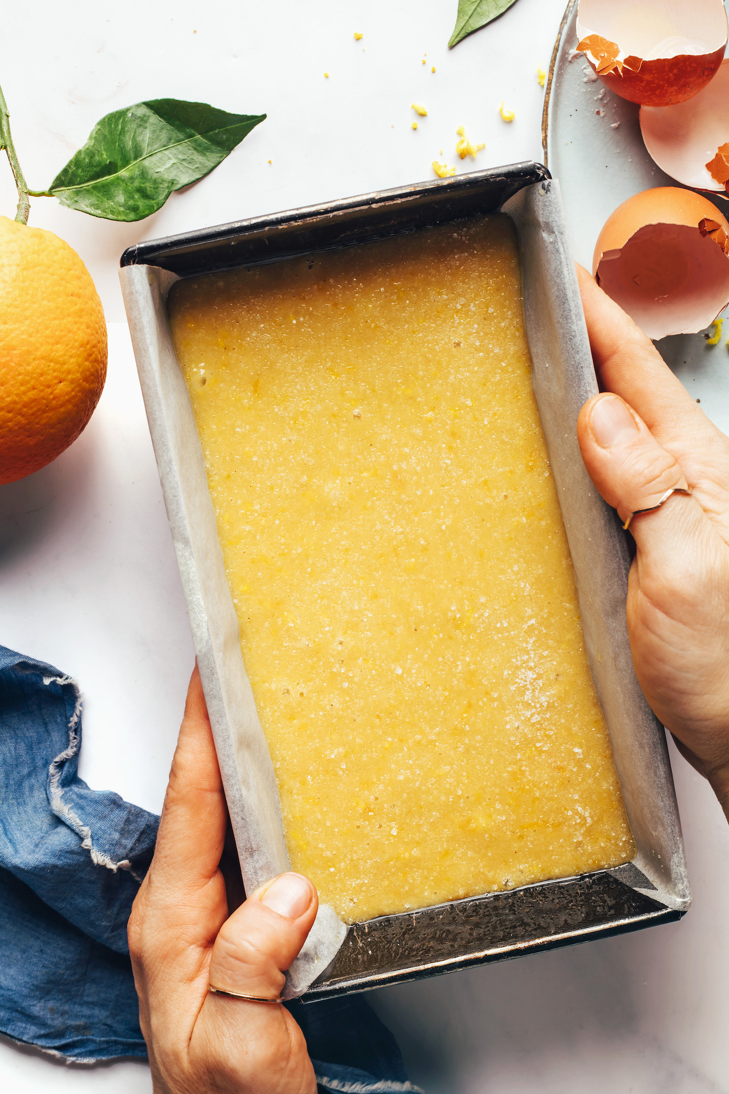 Parchment-lined loaf pan filled with batter