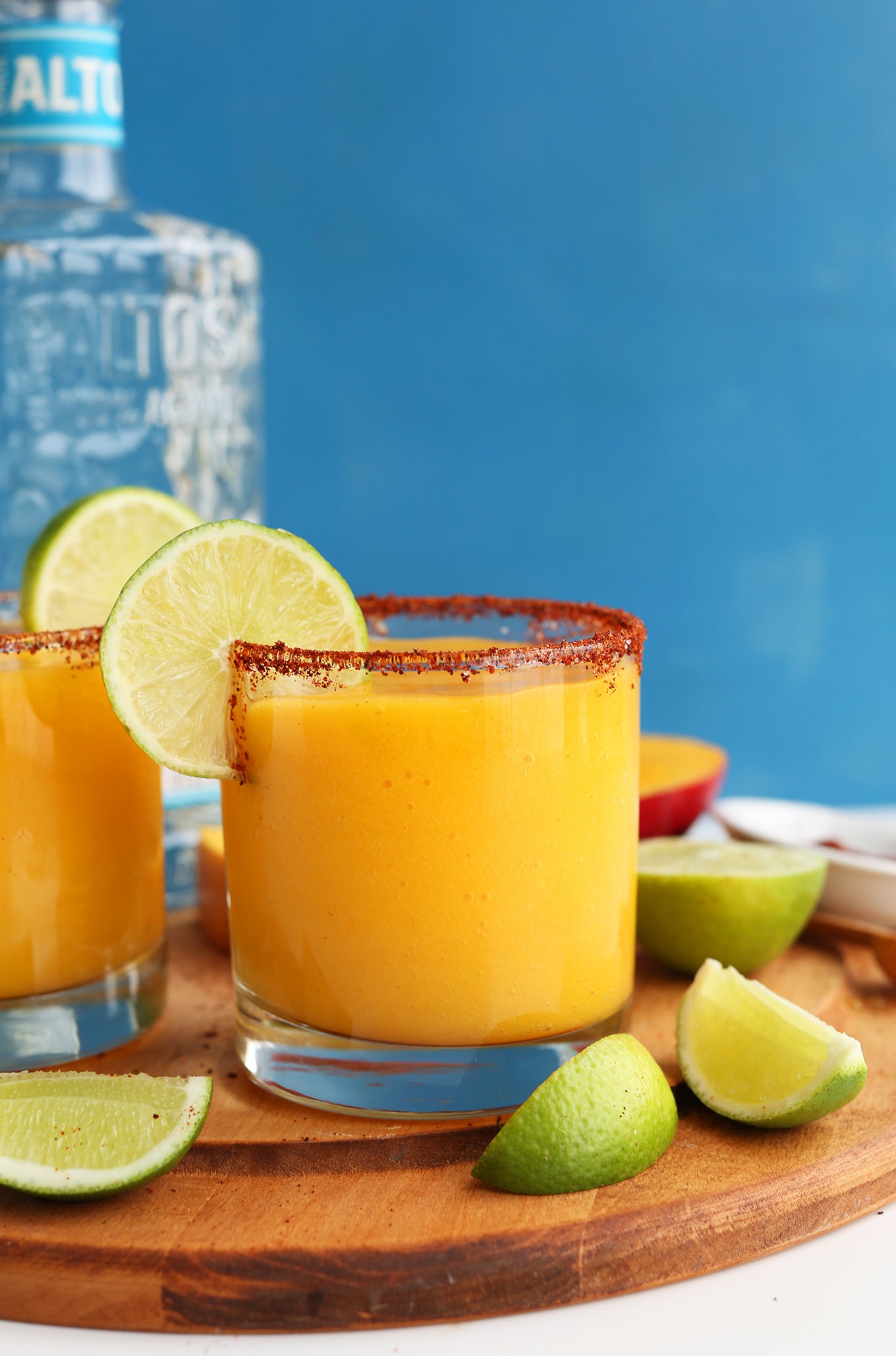 Glasses filled with our Mango Chili Lime Margaritas with a chili powder and fresh lime rim