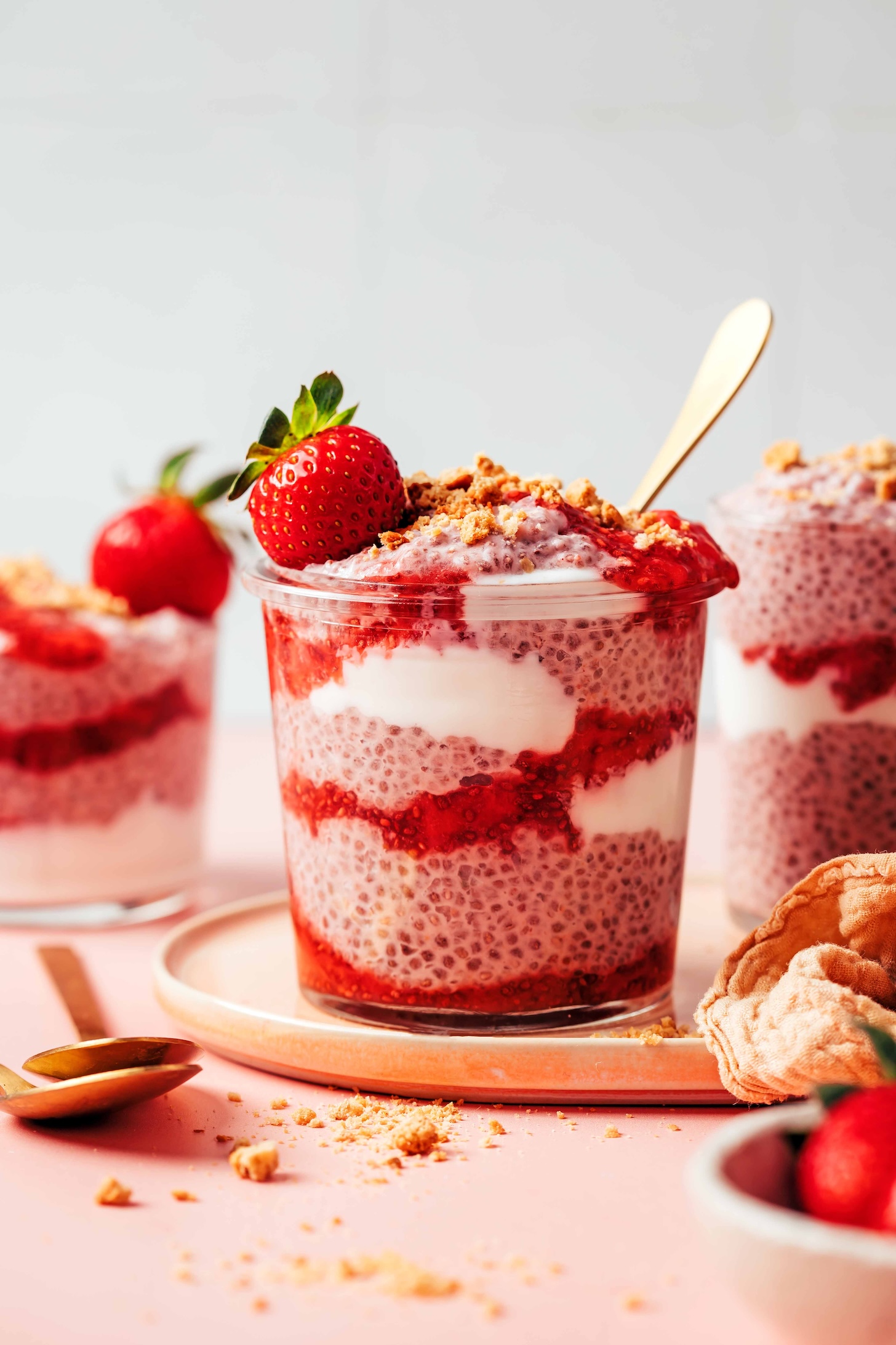 Jar of our strawberries & cream chia pudding layered with strawberry compote, dairy-free yogurt, and crushed graham crackers