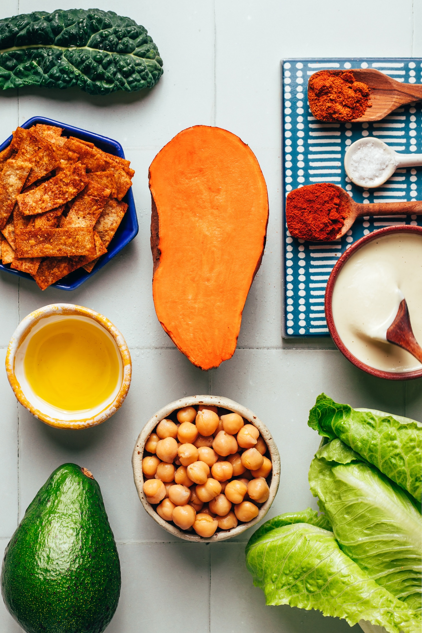 Kale, tortilla strips, sweet potato, oil, avocado, chickpeas, romaine, cashew dressing, smoked paprika, salt, and chili powder