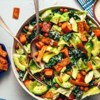 Serving spoon an fork resting in a bowl of our vegan taco salad recipe